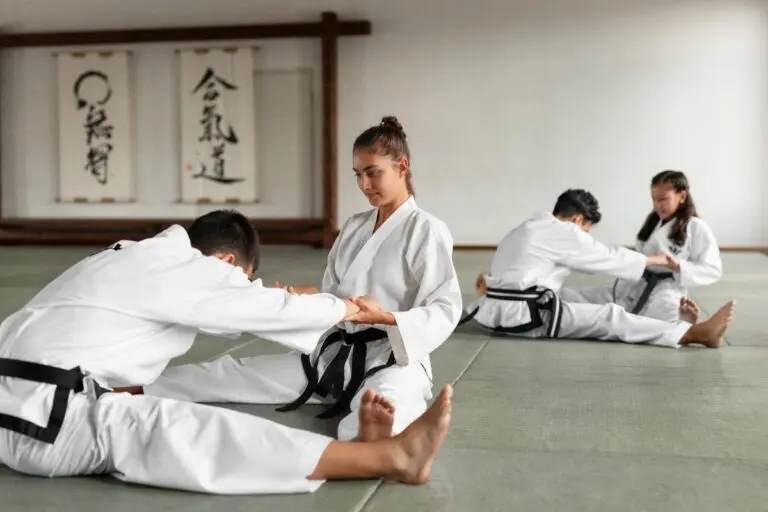 Kids jiu jitsu class practicing ground techniques and partner drills on mats