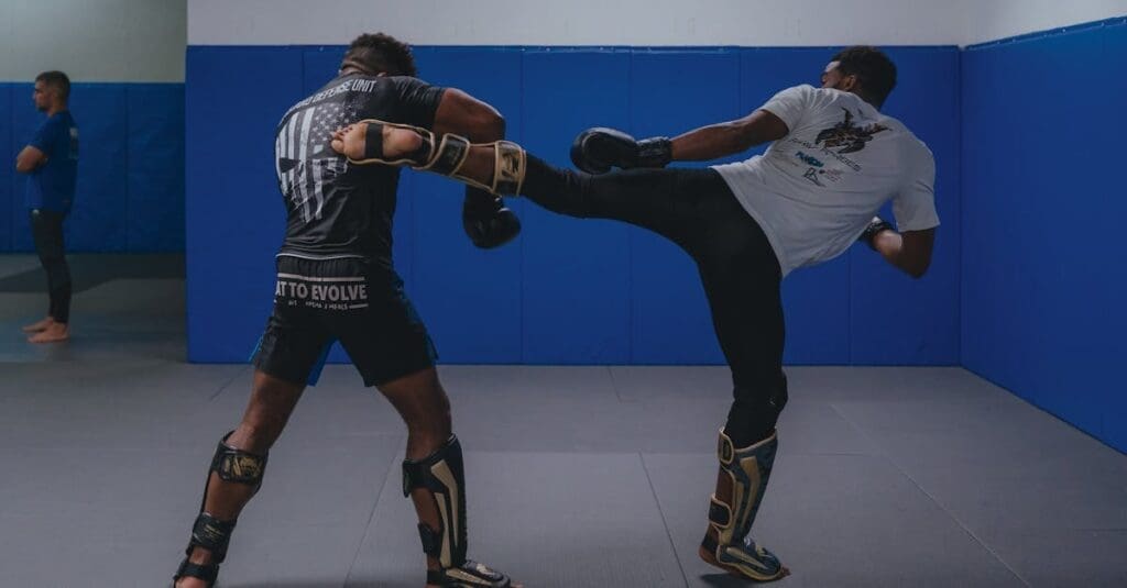 A fighter lands a powerful roundhouse kick on training pads, featured in a beginner kick boxing guide.