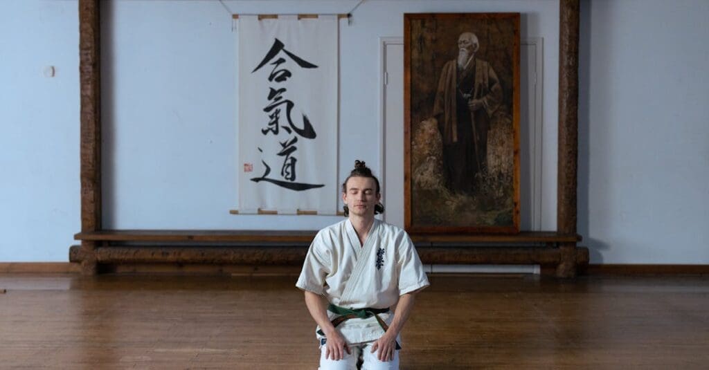 Student meditating before training, showing martial arts training fundamentals