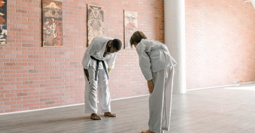 Martial artists bowing before practice, showing martial arts benefits