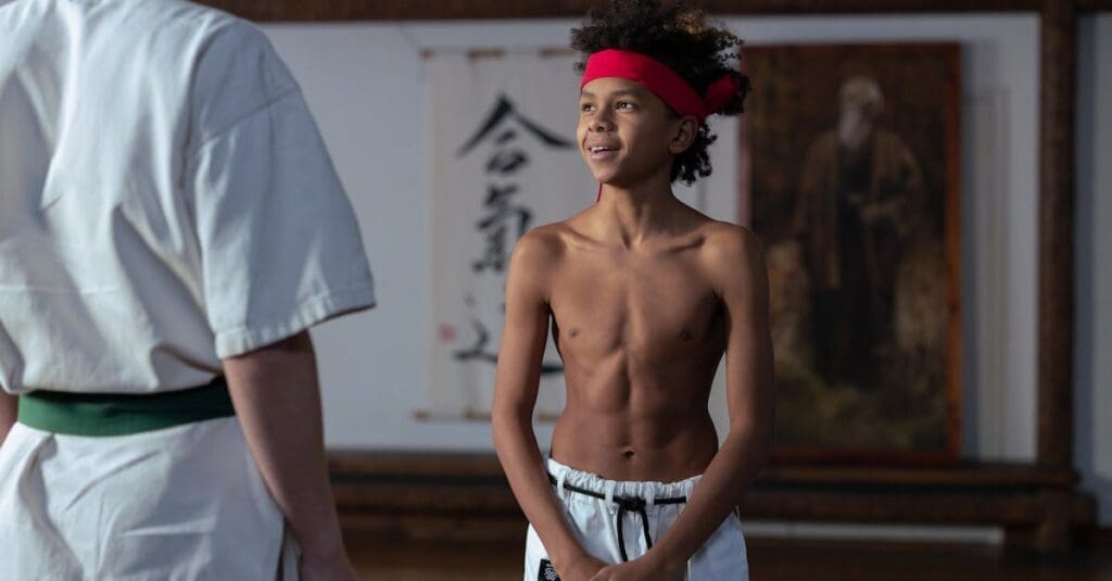 Young student preparing to train with an instructor, showing martial arts training fundamentals